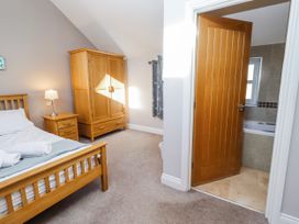 A bedroom with a bed and wardrobe at Bramley in Lucker