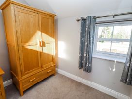 A bedroom with a wardrobe and a window at Bramley in Lucker