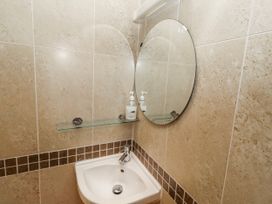 A bathroom with a sink and mirror at Bramley in Lucker