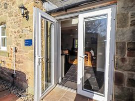 An entryway with double doors opening to a dining area at Bramley in Lucker