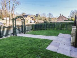 A garden with a gate and pathway at Bramley in Lucker
