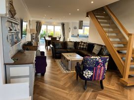 A living room with a sofa and coffee table at Farne Cottage in Beadnell