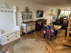 A living room with furniture and decor at Farne Cottage in Beadnell
