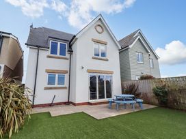 A house with a garden and patio area at Farne Cottage in Beadnell