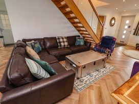 A living room with a sofa and coffee table at Farne Cottage in Beadnell