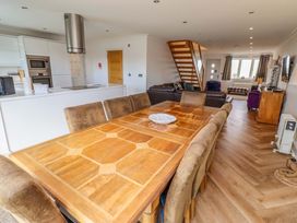 A dining room with a table and chairs at Farne Cottage Beadnell