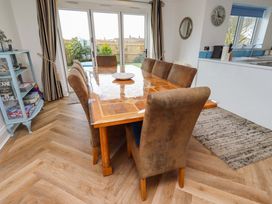 A dining room with a table and chairs at Farne Cottage Beadnell