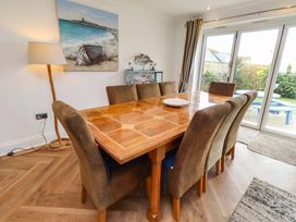 A dining room with a table and chairs at Farne Cottage Beadnell