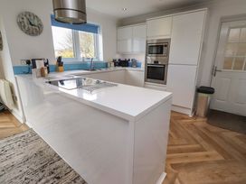 A kitchen with modern cabinetry and appliances at Farne Cottage Beadnell