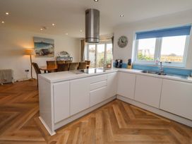A kitchen with a countertop and dinner table at Farne Cottage Beadnell
