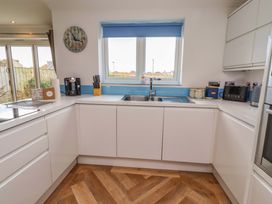 A kitchen with sink and coffee maker at Farne Cottage Beadnell