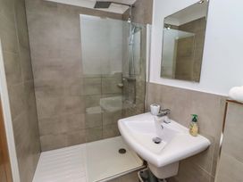 A bathroom with a shower and sink at Farne Cottage Beadnell