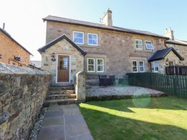 A house with a garden and patio seating area at Russet in Lucker