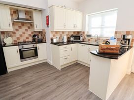 A kitchen with cabinets, appliances, and kitchenware at Russet in Lucker