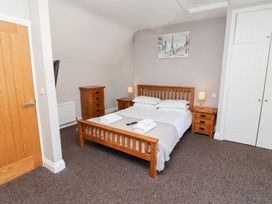 A bedroom with a bed and furniture at Russet in Lucker