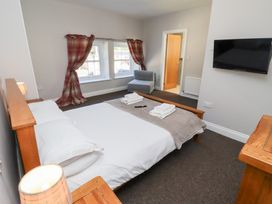A bedroom with a bed and a television at Russet in Lucker