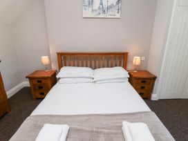 A bedroom with a bed and two nightstands at Russet in Lucker