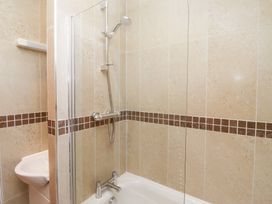 A bathroom featuring a shower in a bathtub at Russet in Lucker