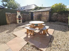 A garden with a table and benches at Russet in Lucker
