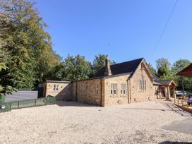 An outdoor area with a building and trees at Russet in Lucker