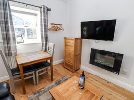 A dining area with a table and chairs at Avocet Cottage - Lucker Steadings Lucker