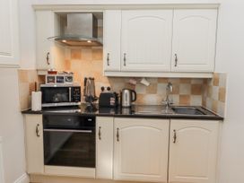 A kitchen with countertop appliances and cabinets at Avocet Cottage - Lucker Steadings in Lucker
