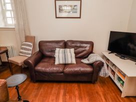 A living room with a sofa and television at No9 Budle Sands in Bamburgh