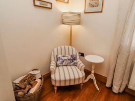 A snug with an armchair and side table at No9 Budle Sands in Bamburgh