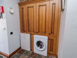 A laundry room with cabinets and appliances at No9 Budle Sands in Bamburgh