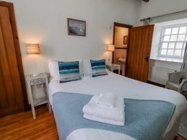 A bedroom with a bed and bedside table at No9 Budle Sands in Bamburgh
