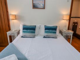 A bedroom with a bed and side tables at No9 Budle Sands in Bamburgh