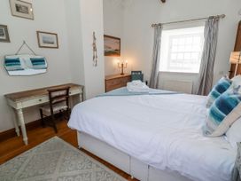 A bedroom with a bed and desk at No9 Budle Sands in Bamburgh