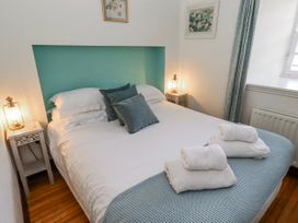 A bedroom with a bed and bedside tables at No9 Budle Sands in Bamburgh