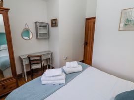 A bedroom with a bed and towels on a blanket at No9 Budle Sands in Bamburgh