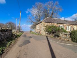 A street view with buildings and trees at No9 Budle Sands in Bamburgh