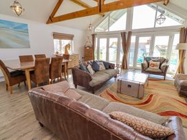 A living room with seating and a dining area at Spindrifter in Beadnell