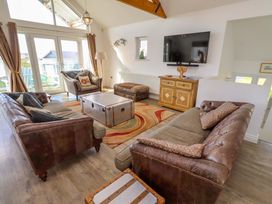 A living room with a coffee table and television at Spindrifter in Beadnell