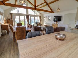 A living room with dining table and sofa at Spindrifter Beadnell