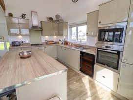 A kitchen with modern cabinets and appliances at Spindrifter Beadnell