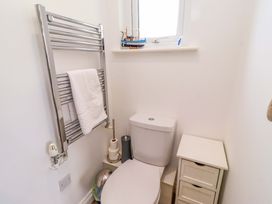 A bathroom with a toilet and towel rail at Spindrifter Beadnell