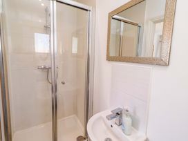A bathroom with a shower and sink at Spindrifter in Beadnell