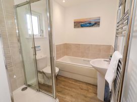 A bathroom with shower, bath, toilet and sink at Spindrifter Beadnell