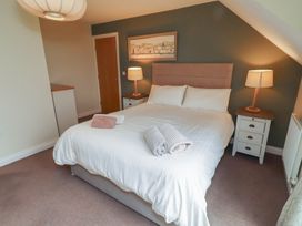 A bedroom with a bed and bedside tables at The Beach Hut in Beadnell