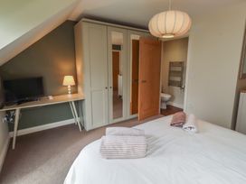 A bedroom with a bed and television at The Beach Hut in Beadnell