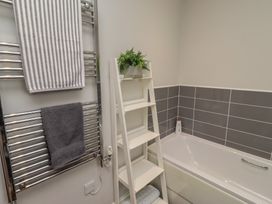 A bathroom featuring a towel rack and a bathtub at The Beach Hut in Beadnell