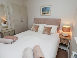 A bedroom with a bed and wardrobe at The Beach Hut in Beadnell