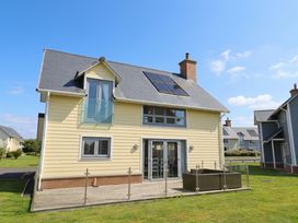A house with solar panels and decking at The Beach Hut in Beadnell