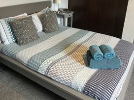 A bed with pillows and towels at Beach Retreat in Seahouses