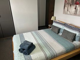 A bedroom with a bed and towels at Beach Retreat in Seahouses