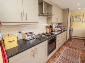 A kitchen with cabinets, stove, toaster, and fridge at Number Seventeen Amble
